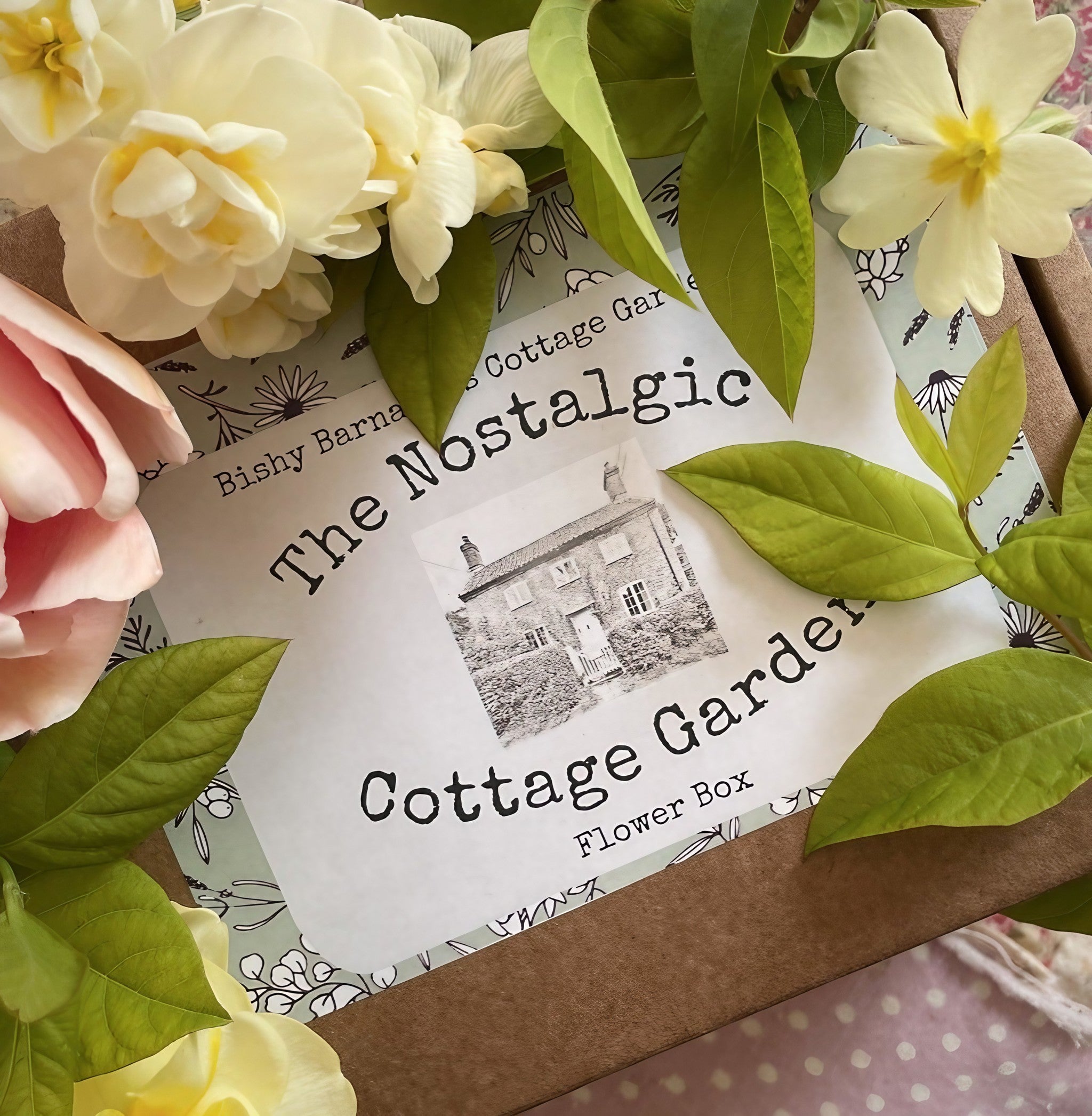 The Nostalgic Cottage Garden Flower Box with vintage-style flowers and greenery surrounding the package.