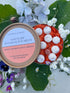 Sanctuary Botanical Wax Melts in a eco-friendly packaging displayed among flowers and leaves.