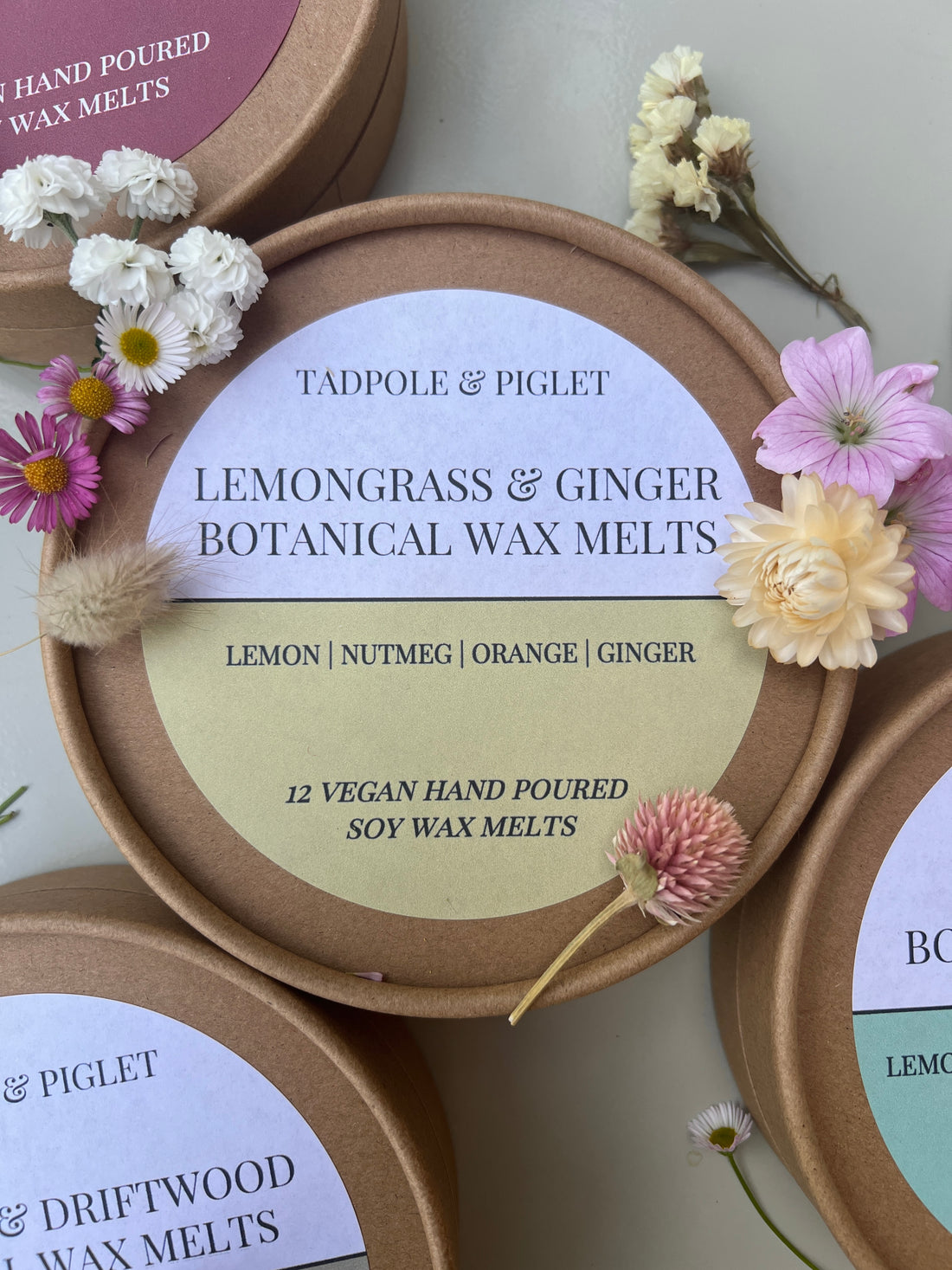 Lemongrass &amp; Ginger Botanical Wax Melts packaging with floral decorations and ingredients label shown.