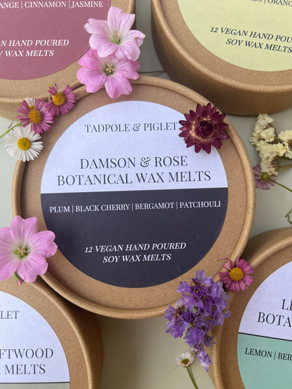 Damson &amp; Rose Botanical Wax Melts tin with flowers, featuring scents of plum, black cherry, and bergamot.