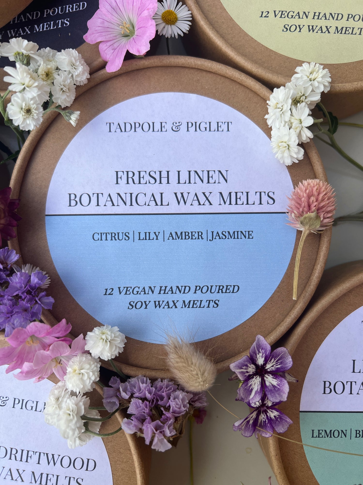 Fresh Linen Botanical Wax Melts by Tadpole &amp; Piglet with floral accents, highlighting citrus and jasmine scent notes.