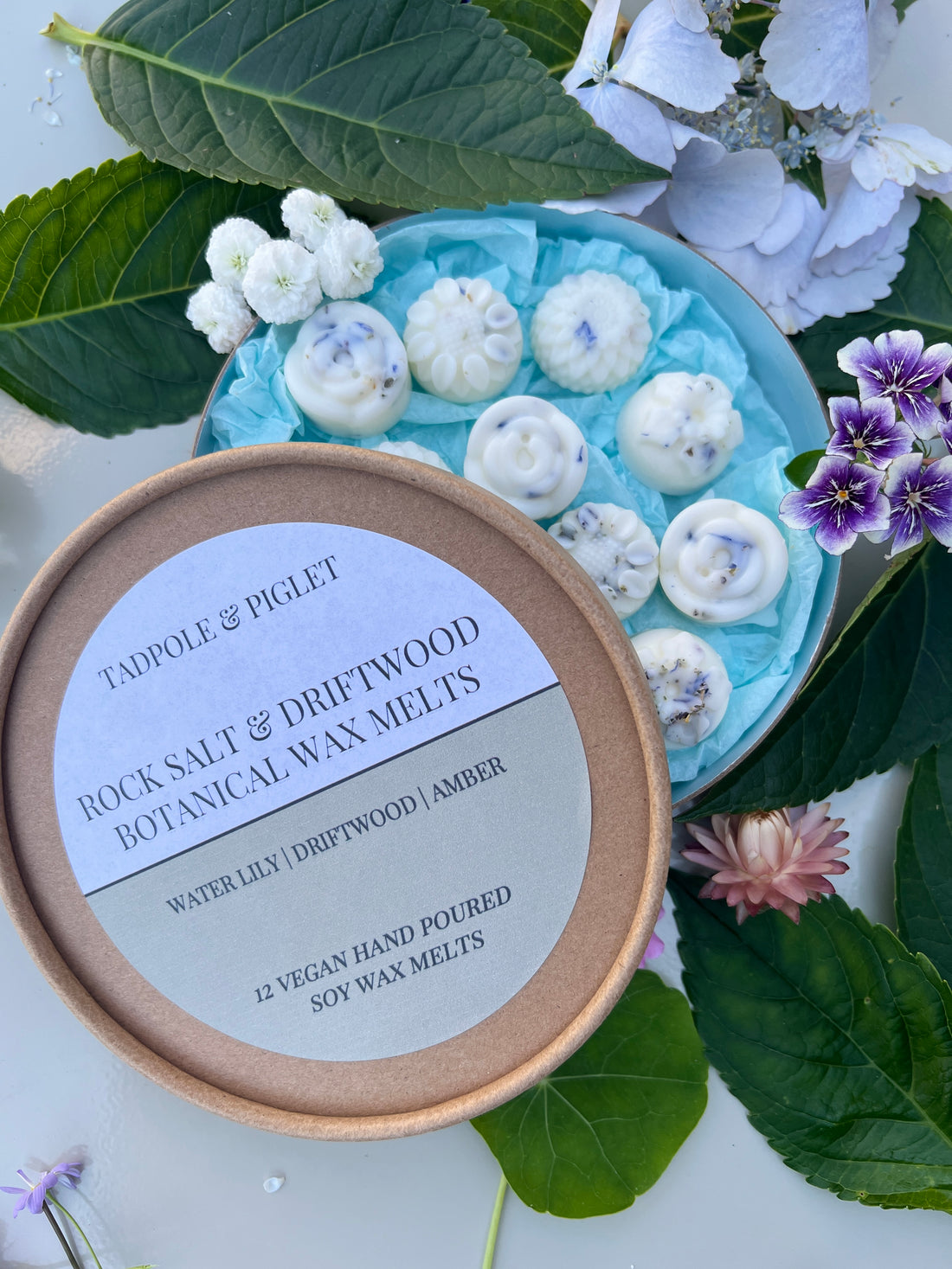 Rock Salt &amp; Driftwood Botanical Wax Melts with water lily and driftwood scent, 12 vegan hand-poured soy wax melts in a decorative container.