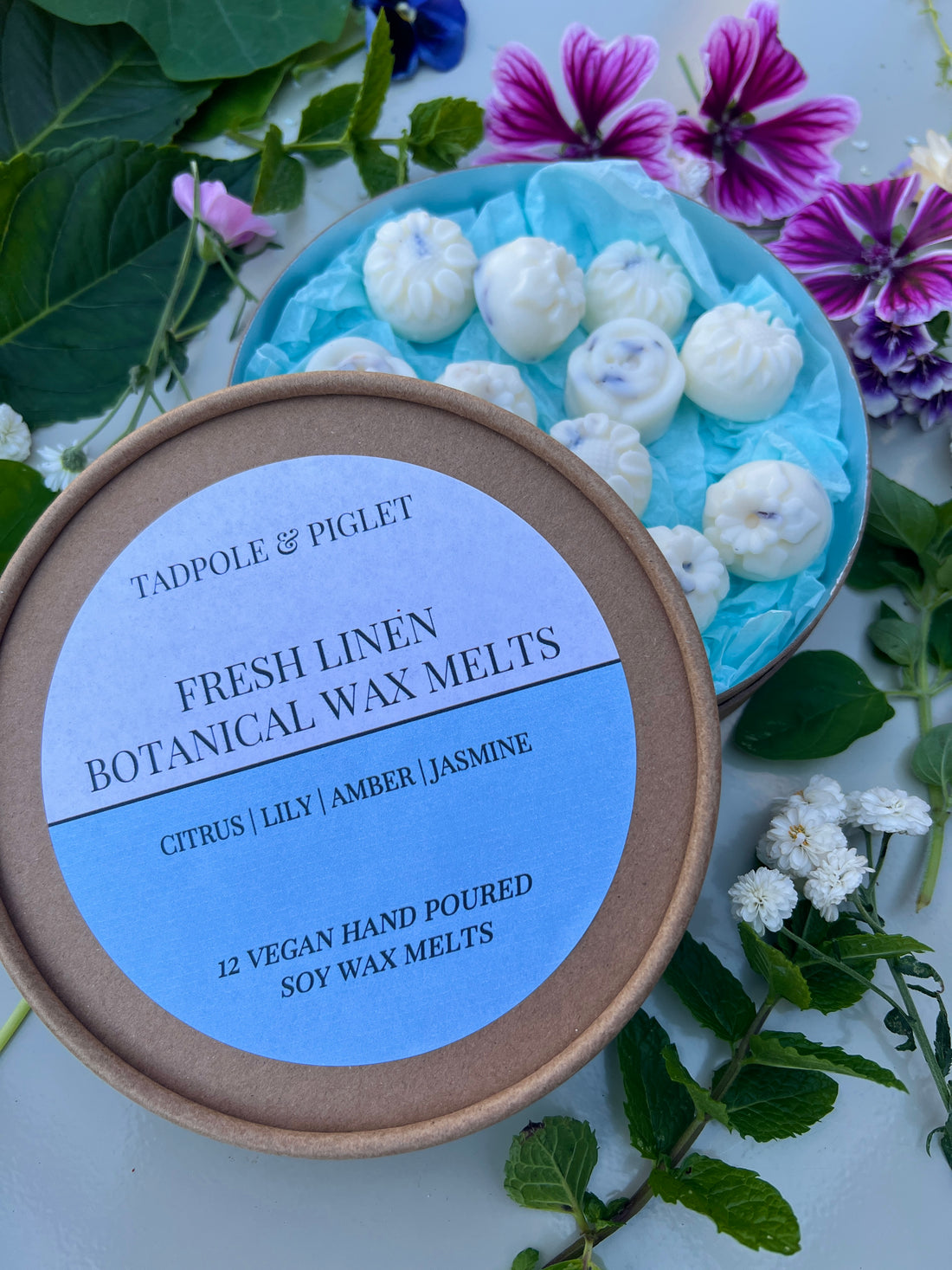 Fresh Linen Botanical Wax Melts with floral accents and greenery, citrus, violet, orange blossom, jasmine, lily, and galbanum aromas