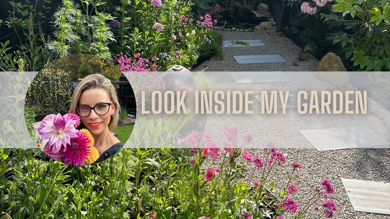 Woman holding colorful flowers in a vibrant garden with a pathway, inviting viewers to explore her garden.